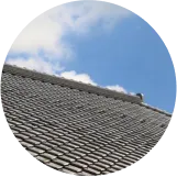 青空の下に広がる日本家屋の瓦屋根。リフォーム後の様子。